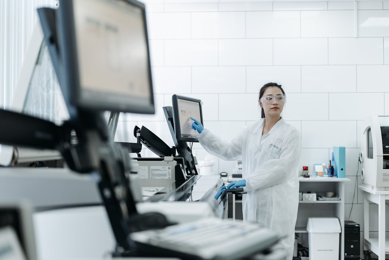 ours-journey Lab technician in a white coat using medical equipment in a modern laboratory setting.